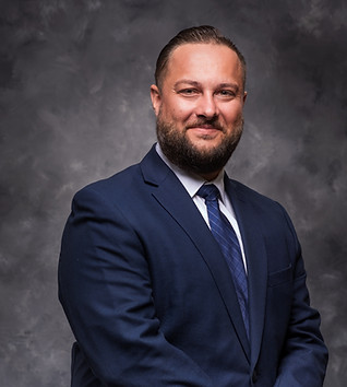 Smiling businessman in blue suit posing for photo, Fortress Mortgage Ad.