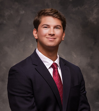 Smiling man wearing a suit and tie, Fortress Mortgage Ad on display.