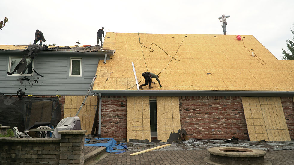 RoofCo crew working on exposed roof decking during a roof replacement