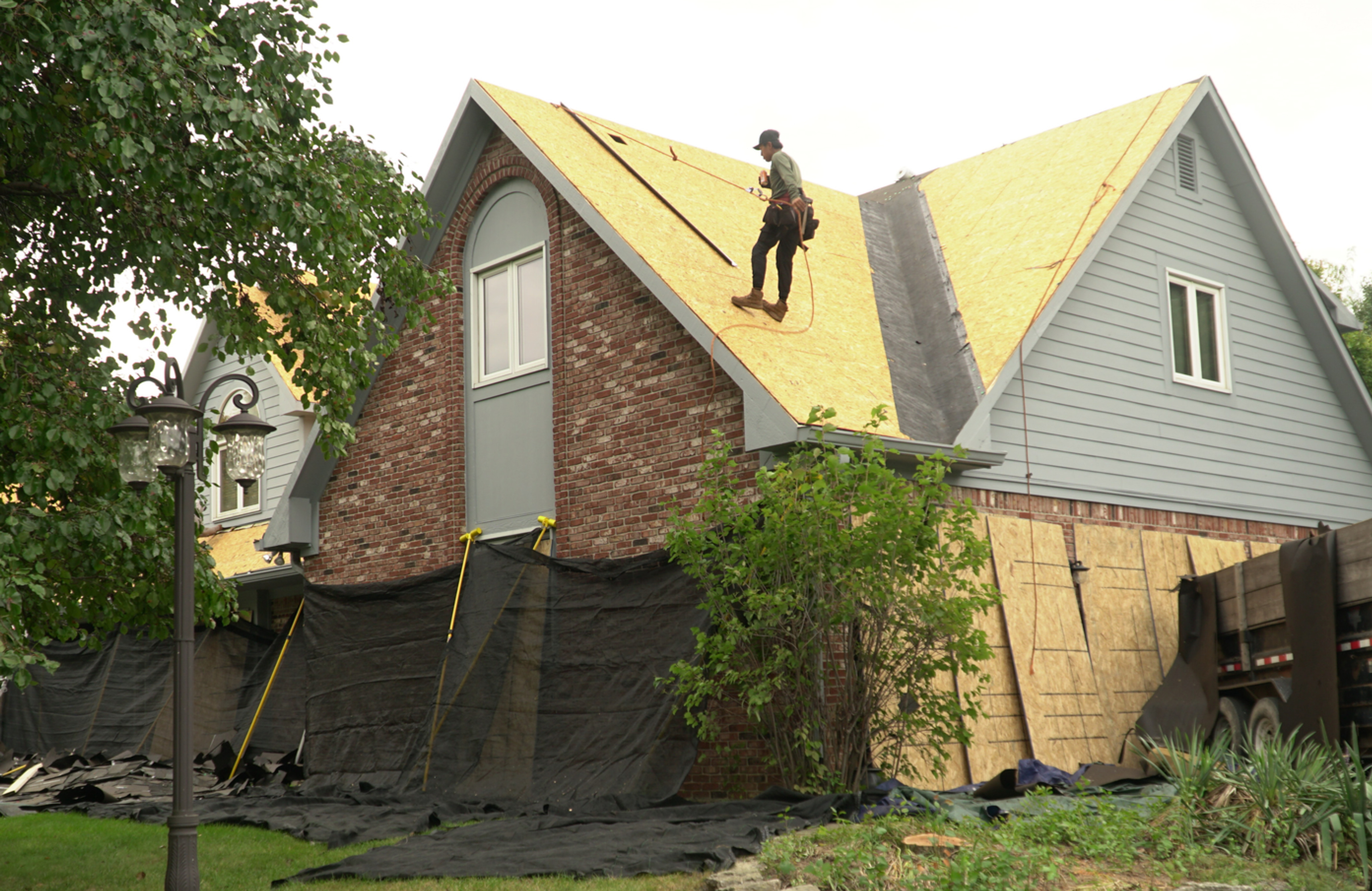 Residential roof replacement in progress on a gabled Central Indiana home