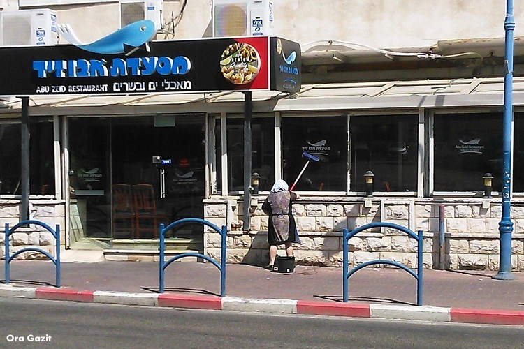 אשה מנקה חלון - בת גלים - שביל חיפה - טרק - טיול בחיפה