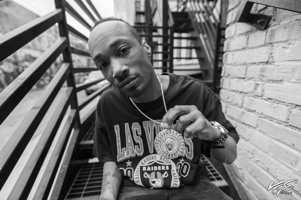 Martell Harris, a Fargo-based real estate agent and hip-hop artist, photographed in Fargo’s legal graffiti alley. Captured by Fargo photographer KGE Photography for The Wide View Project using a wide-angle lens to emphasize texture, energy, and urban creativity.