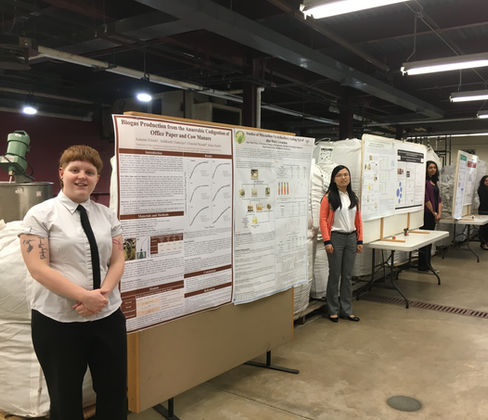 The photo shows me and several others by our research posters.