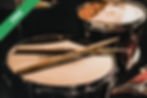 Drumsticks resting on a drum