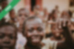 A smiling boy surrounded by other children