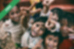 Five children smiling and making peace signs