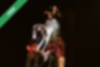 Performers forming a group shape on stage