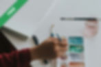 A person dipping a paintbrush in paint