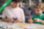 Two children making paper crafts together