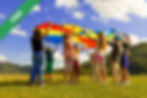 Children playing with a colourful parachute