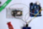 A breadboard circuit with a soil moisture sensor