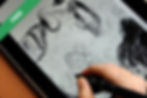 A person drawing on a tablet with a stylus