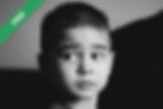 A young boy looking to the side with wide eyes