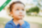 A young child thinking with a finger on her chin