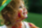 A girl with paint on her face and arms