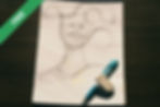 A pencil sketch of a face on a notepad