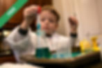 A boy holding a red and clear plastic tool