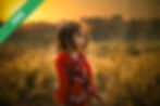 A girl standing near a field