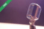 A vintage microphone against a purple background