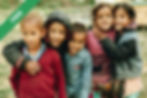 A group of children standing on a grass field