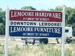 Lemoore Hardware and Lemoore Furniture mounted marketing sign in the country