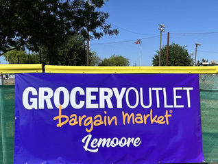 Printed Grocery Outlet of Lemoore Sponsor banner on the Lemoore Little League Field