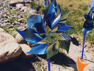 Blue pinwheels represent child abuse awareness in front of the police station in Avenal
