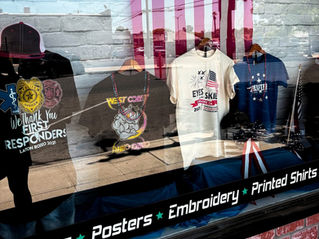Patriotic t-shirts and VFA t-shirts in front window at Plain Insane Graphix in Lemoore