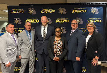 Elder Abuse Taskforce members posing for a photo on the stage of a conference