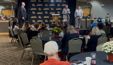 Elder Abuse Taskforce members speaking to attendees of an annual Elder Abuse conference
