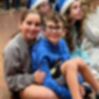 children sitting together and enjoying a Hanukkah event