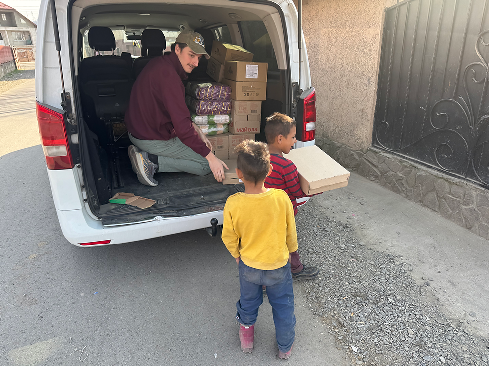 Orphan kids helping Izi unload the van