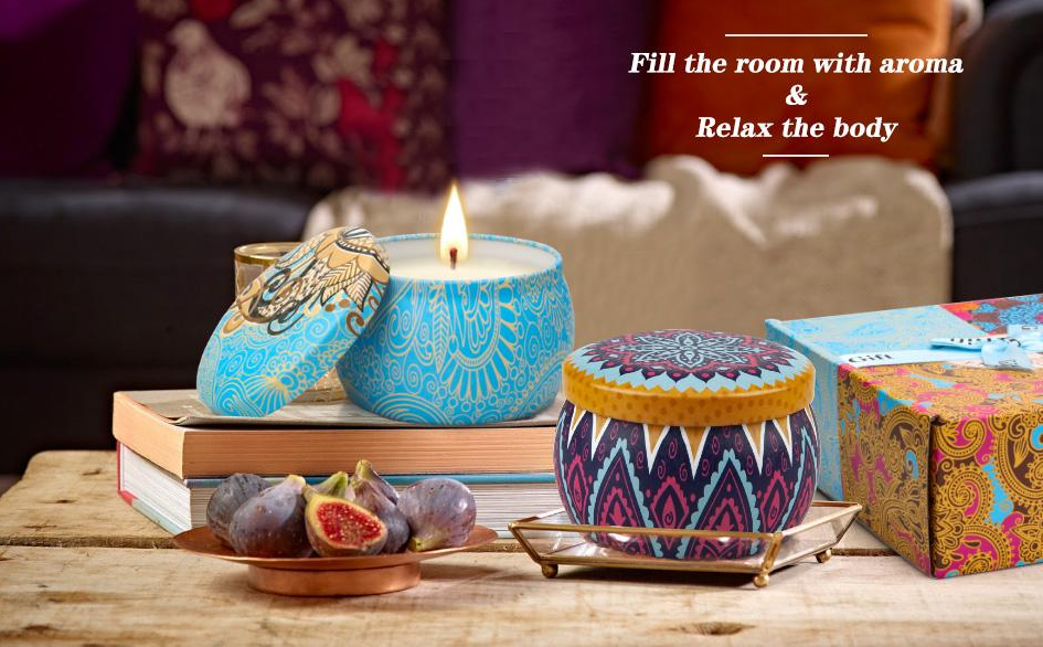 Lit candle in blue patterned tin, figs on a plate, and books on a wooden table. Text: "Fill the room with aroma & Relax the body." Cozy setting.