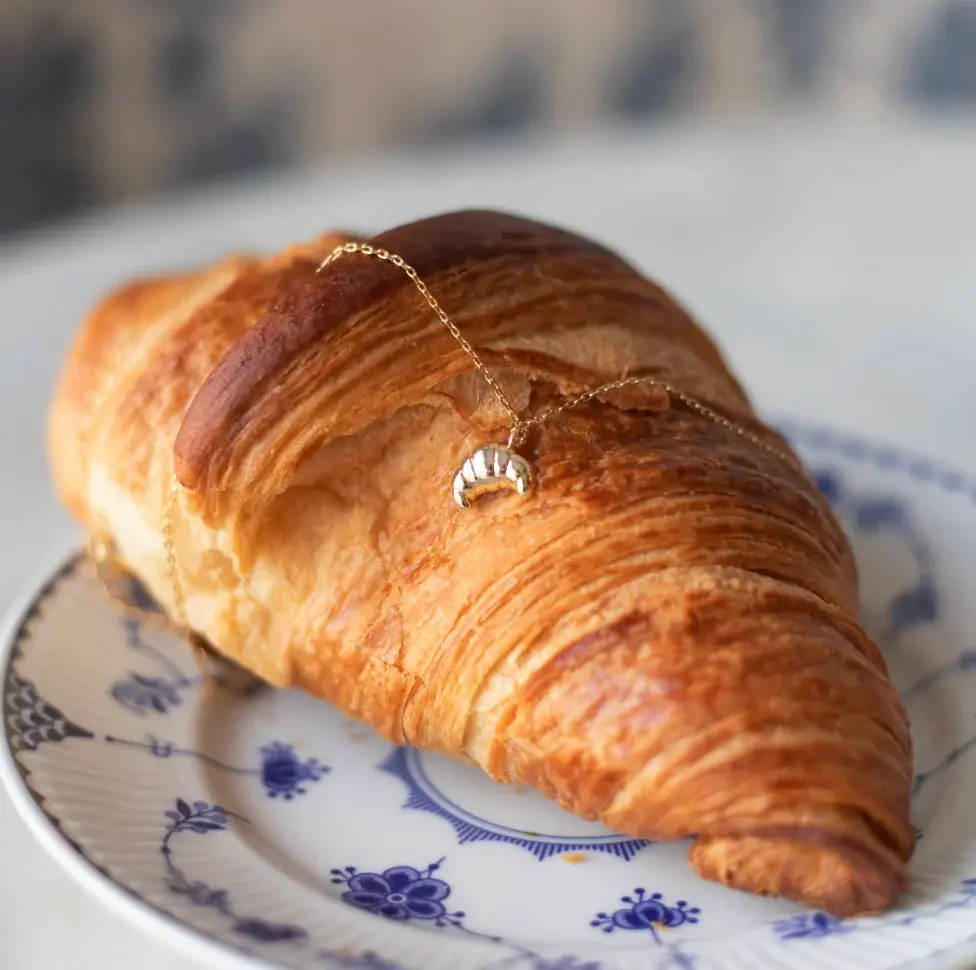 Croissant and necklace with a croissant.