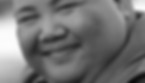 Close-up black and white portrait of a smiling person