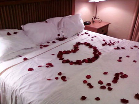 A romantic heart shape of rose petals setting the mood for a proposal.