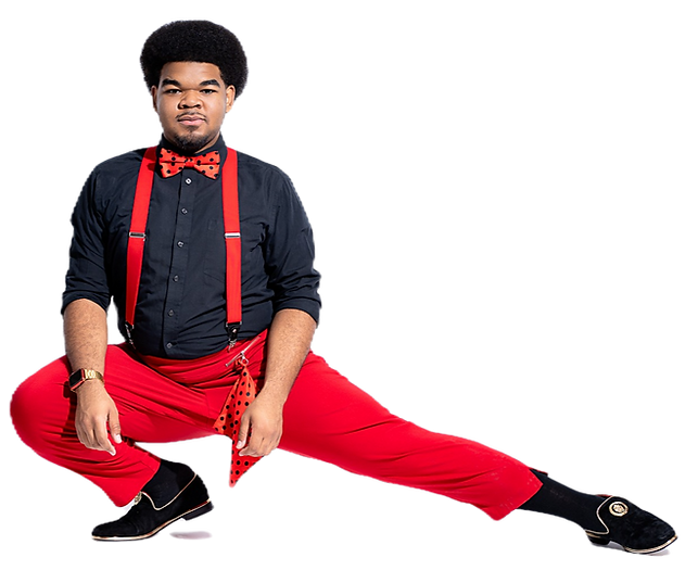 Derrian Brown wearing a black dress shirt with red pants, red suspenders, and a black and red bowtie.