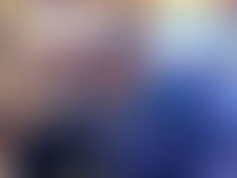 A diverse group of smiling adults sit together in a church pew, symbolizing the welcoming and inclusive spirit of Newport Sings’ Community Sing gatherings.