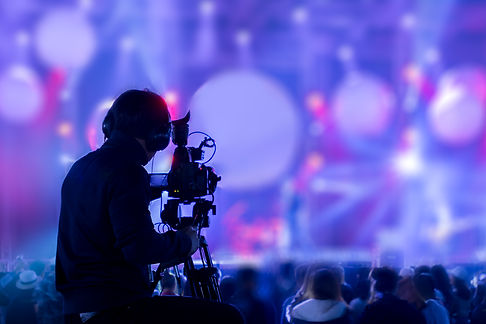 silhouette-man-covering-event-stage-with-video-camera.jpg