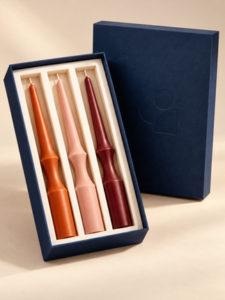 Three tapered candles in a blue gift box