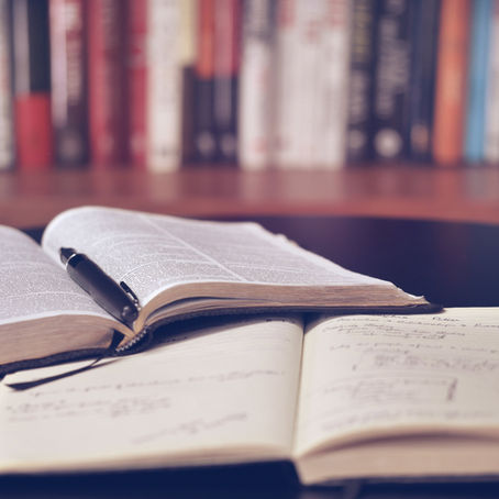 Open notebook and pen — studying the Lord's Prayer word by word