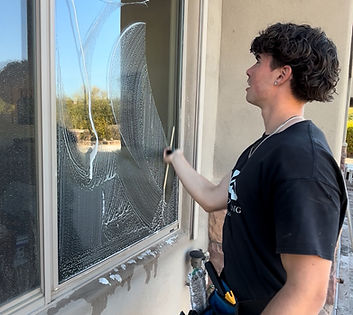 Professional window cleaner working on residential window cleaning in the Valley