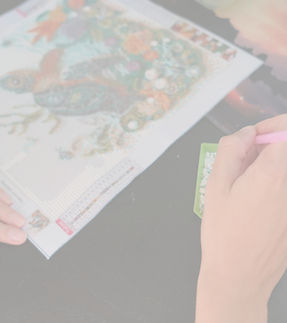 Person creating a diamond painting of a 