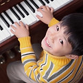 A piano student preparing for ABRSM or TRINITY practical music exam.