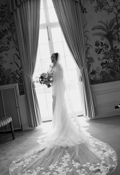 bride standing in window in mansion