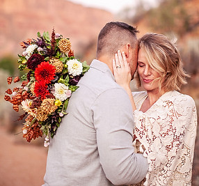 married couple featuring floral bouquet