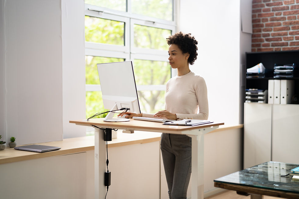 Modern adjustable standing desk setup with thin monitor.