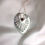 Thumbnail: Sterling silver leaf shaped pendant. Art Nouveau inspired. Set with a 5mm round red garnet stone in the centre.