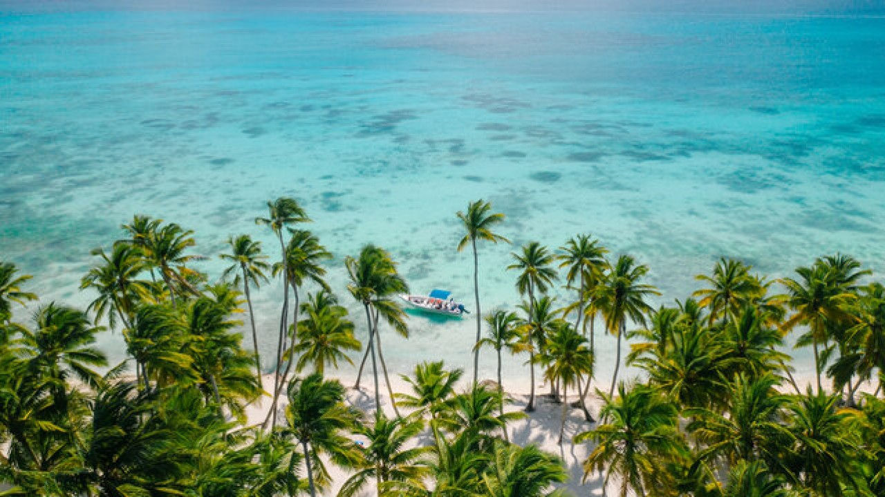 Crystal-clear turquoise waters seen during Saona Island meeting point tour.