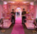 Pink castle event entrance with uniformed staff by Stellar Events